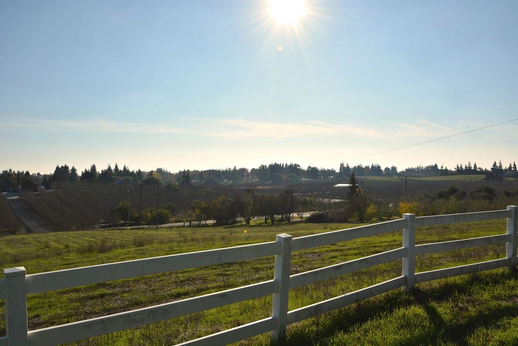 Wooden ranch fence and open rangeland outside Oakdale