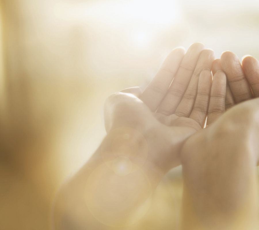 Open hands lifted in prayer