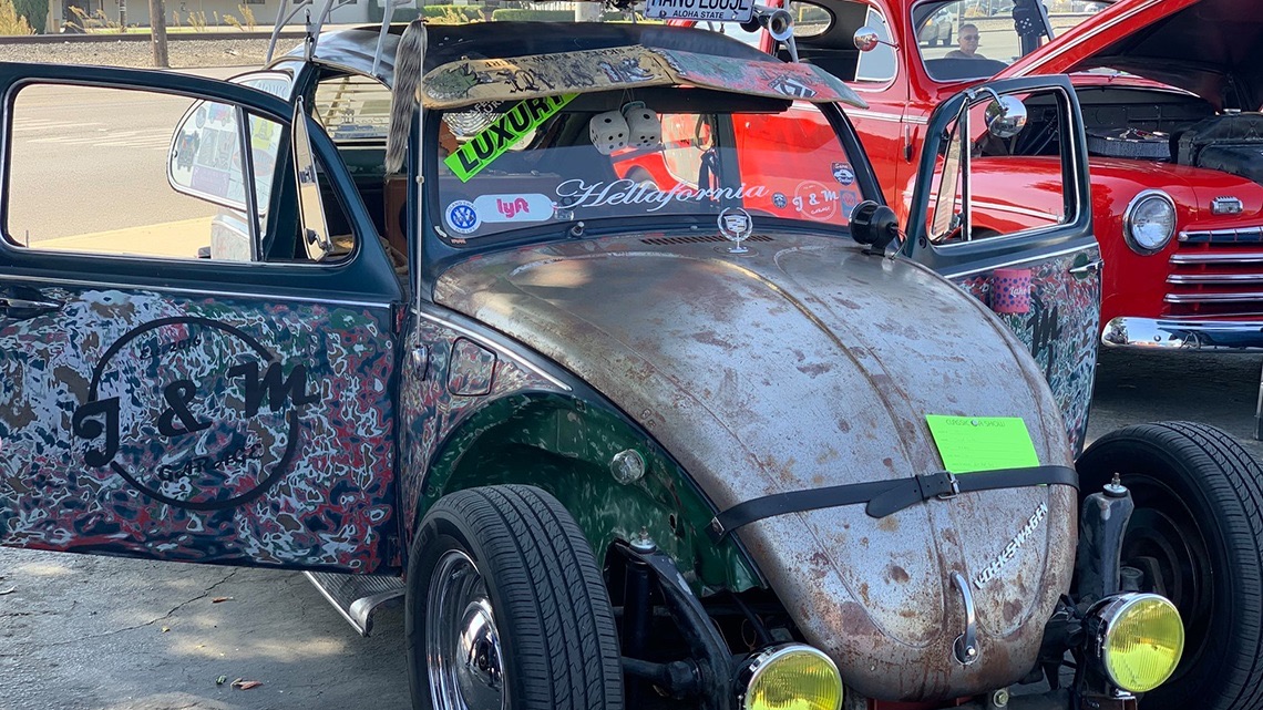Classic cars parked in rows at a car show in the Yosemite Lanes parking lot
