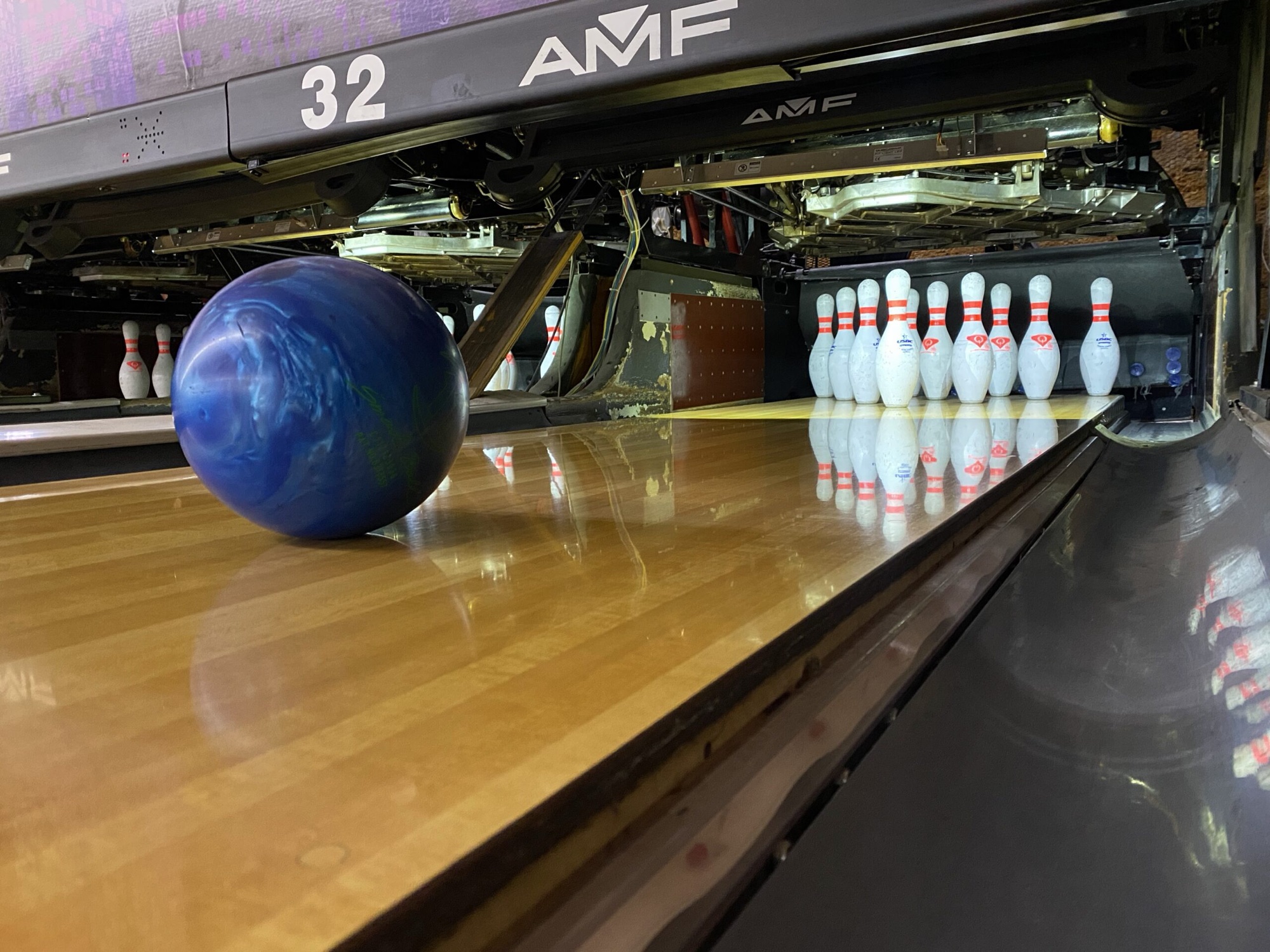 Inside Yosemite Lanes at dusk — long rows of polished lanes stretching toward the pins